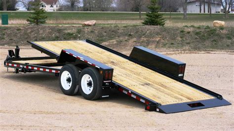 Towmaster trailers - The Towmaster® T-series large drop-deck trailer is designed for hauling larger mid-sized equipment. This model is built on a stout cold-formed I-beam tongue and main frame and features a 3-inch lip around the deck. The oak wood deck is supported by strong 3-inch I-beam crossmembers and Dexter® Torflex® rubber